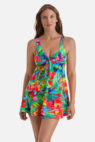 Woman wearing a multicolor palm leaf printed swim dress with a tie in the front