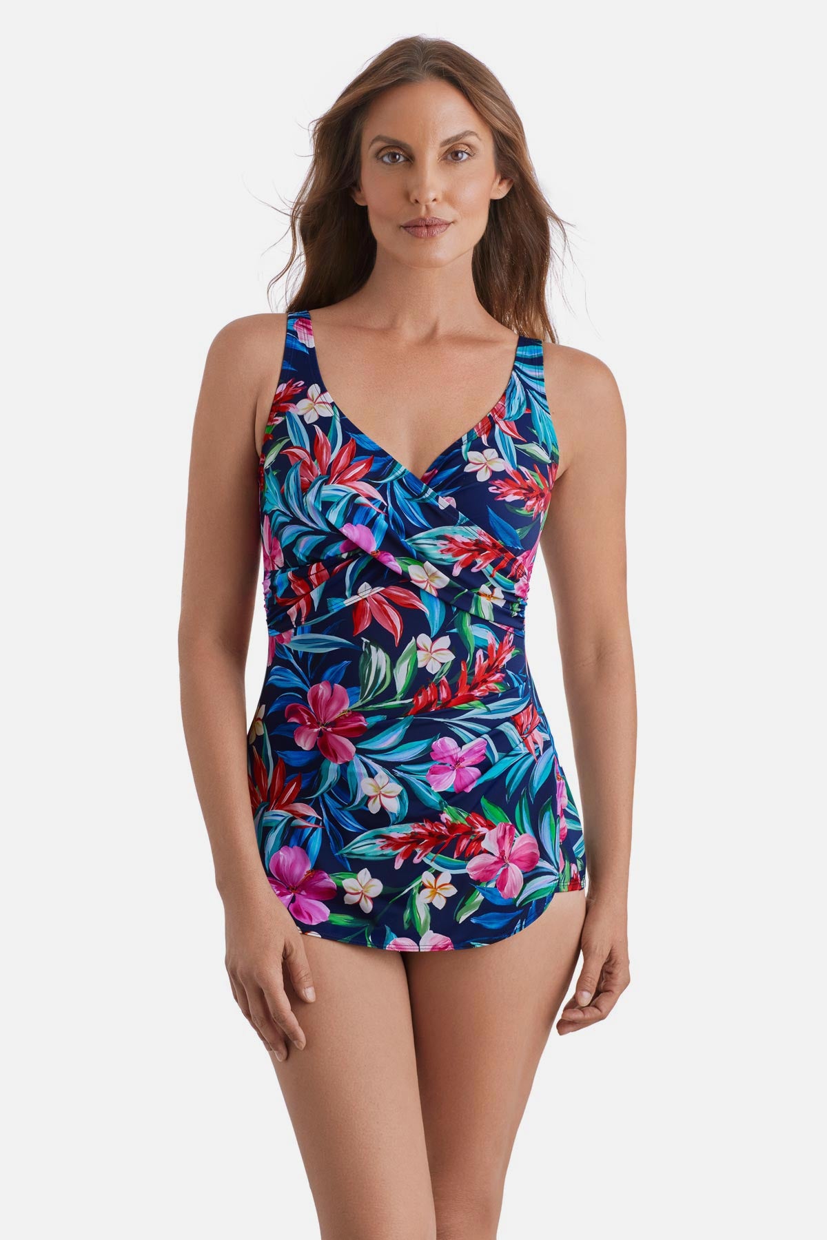 Woman wearing a multicolored floral and palm leaf printed sarong one-piece swimsuit