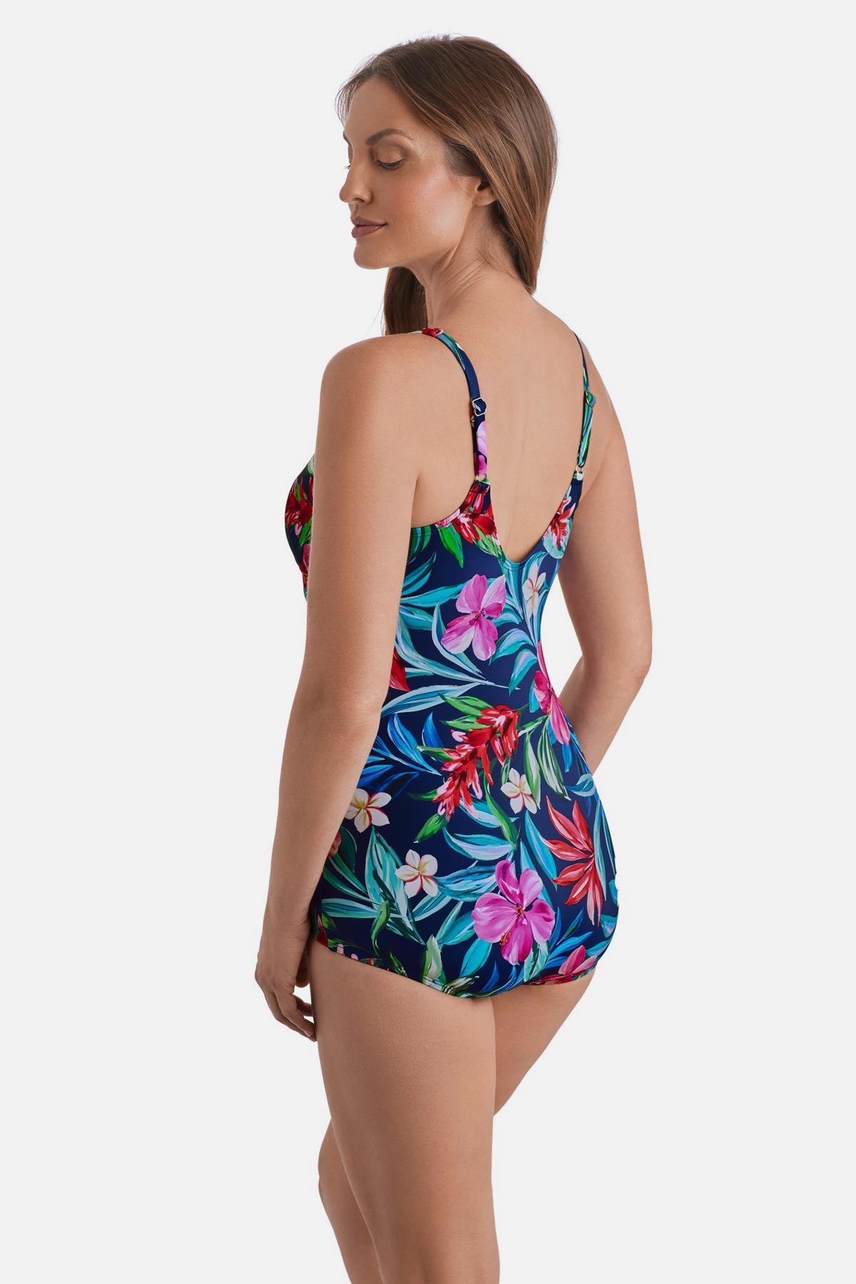 Woman turned left wearing a multicolored floral and palm leaf printed sarong one-piece swimsuit