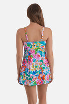 Woman turned away wearing a multicolored floral print square neck swim dress
