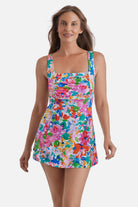Woman wearing a multicolored floral print square neck swim dress