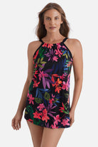 Woman wearing a multicolored floral printed halter swim dress