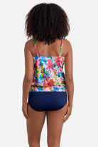 Woman turned away wearing a multicolored floral print blouson tankini top