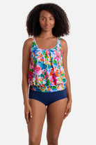 Woman wearing a multicolored floral print blouson tankini top