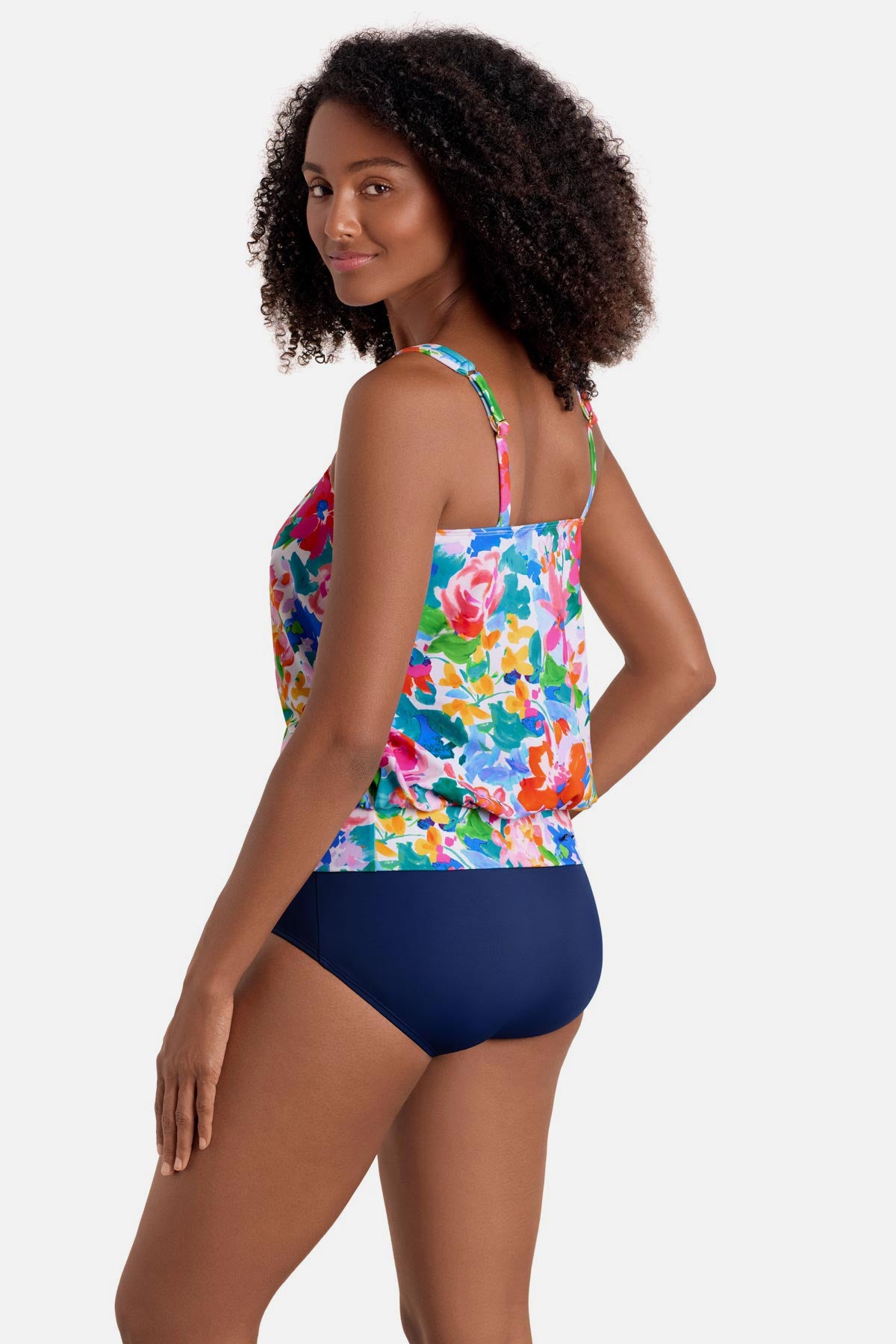 Woman turned left wearing a multicolored floral print blouson tankini top