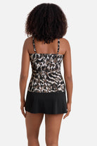 Woman turned away wearing a brown animal-esque printed tankini top