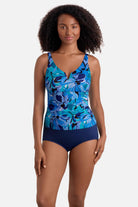 Woman wearing a blue floral printed shirred tankini top