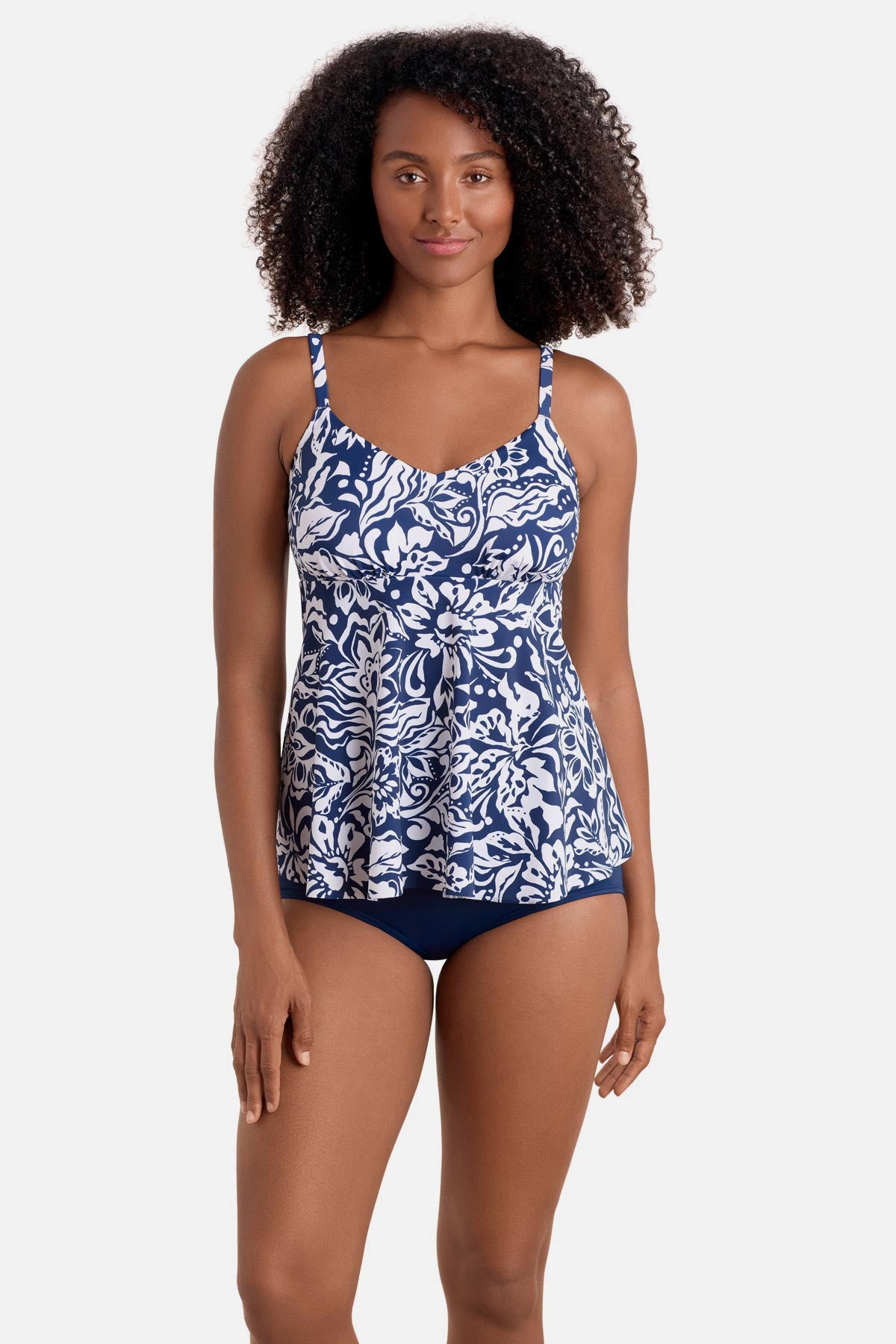 Woman wearing a blue and white abstract floral printed tankini top