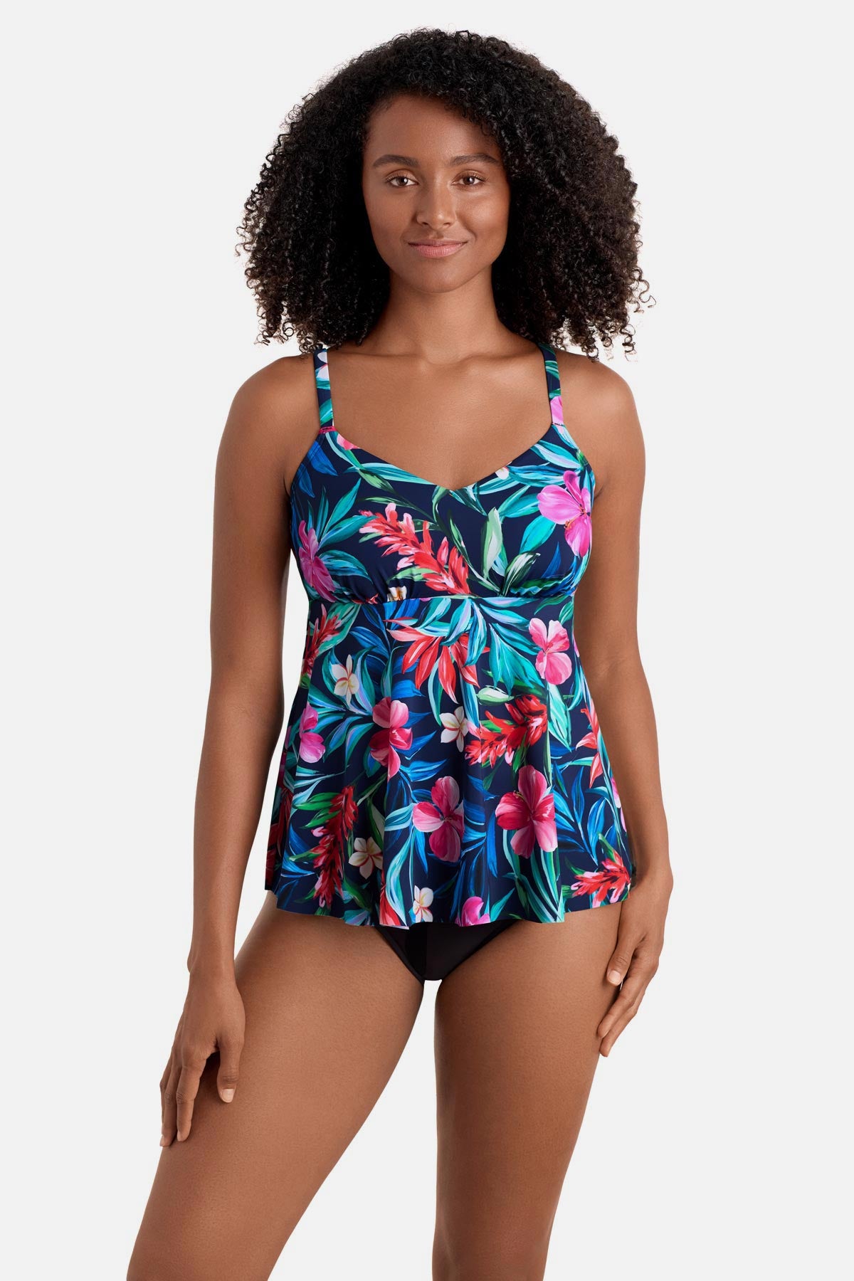 Woman wearing a multicolor floral and palm leaf print tankini top 