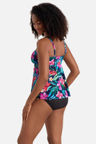 Woman turned left wearing a multicolor floral and palm leaf print tankini top 