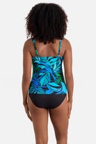 Woman turned away wearing a blue and green palm leaf print square neck tankini top