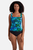 Woman wearing a blue and green palm leaf print square neck tankini top
