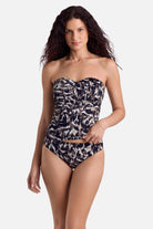 Woman wearing an animal skin print bandeau tankini top with matching swim bottoms