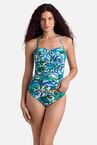 Woman wearing a blue and green floral printed bandeau tankini top