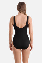 Woman turned away wearing a one-piece swimsuit