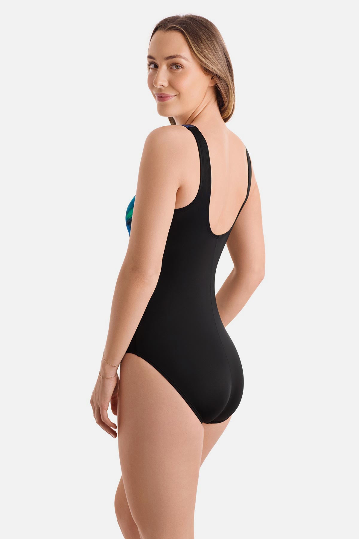 Woman turned left wearing a blue and green tie dye one-piece swimsuit