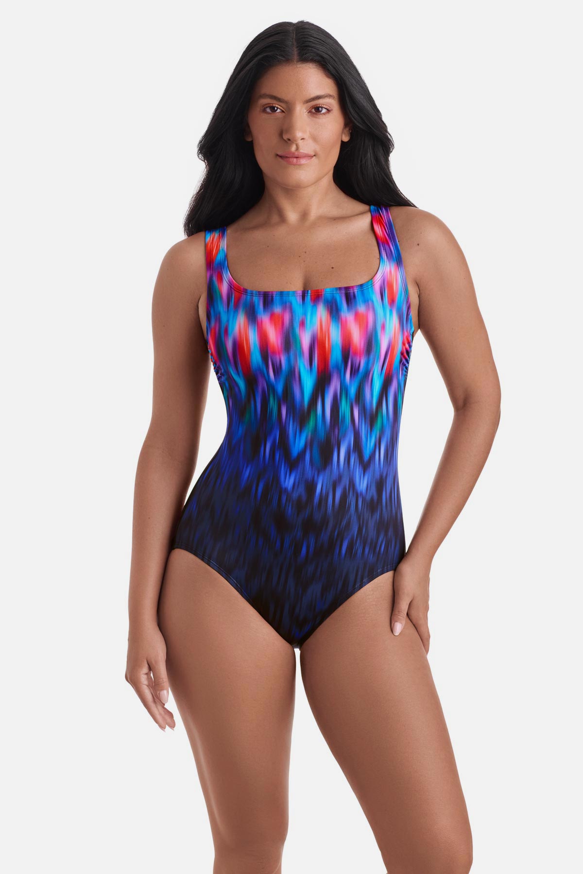 Woman wearing a multicolored tie die one-piece swimsuit