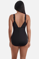 Woman turned away wearing a one-piece swimsuit 