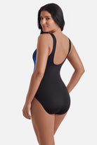 Woman turned left wearing a blue electric printed one-piece swimsuit