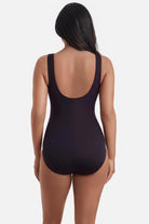 Woman turned away wearing a black one-piece swimsuit