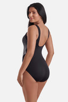 Woman turned left wearing a black and white radial pattern one-piece swimsuit