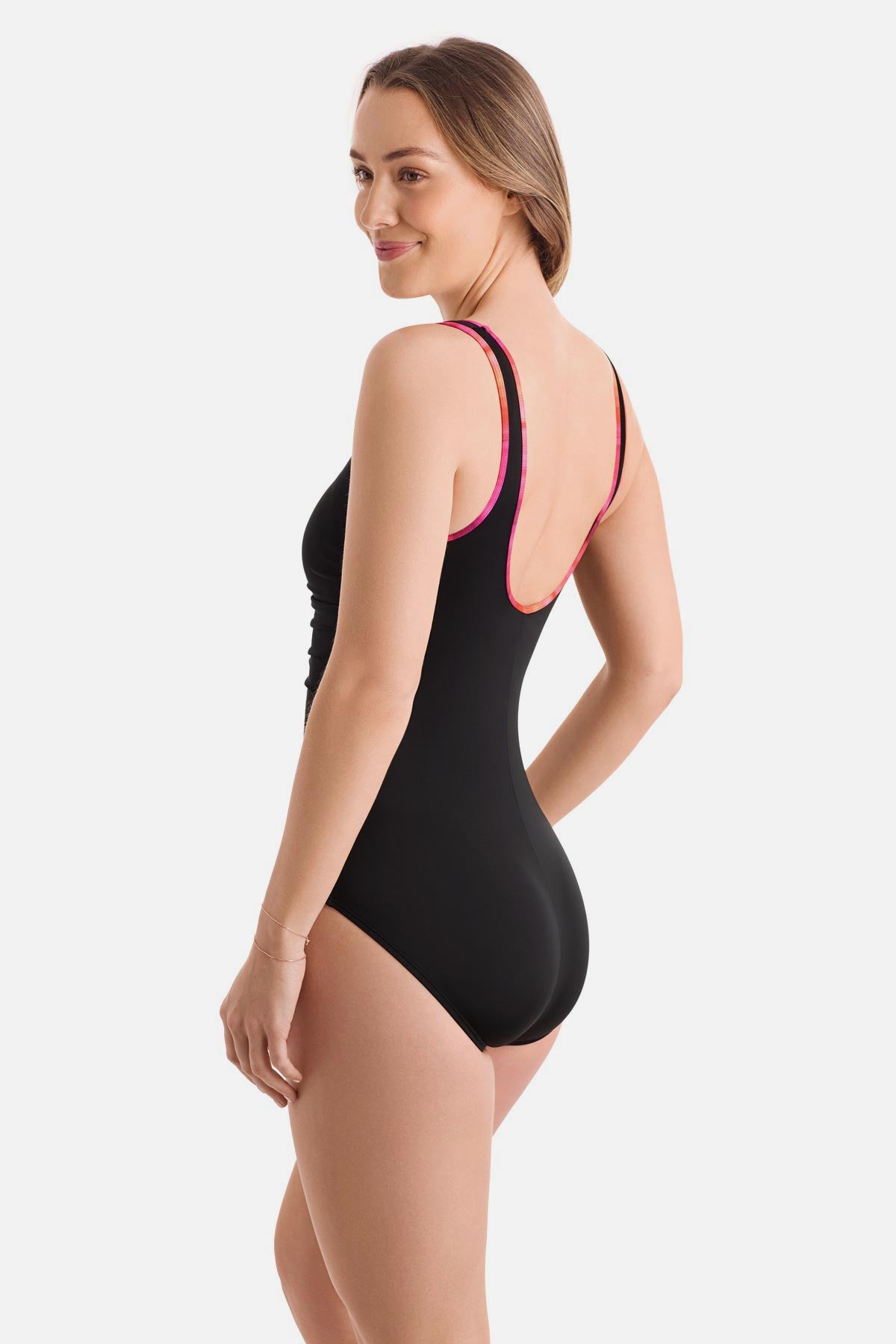 Woman turned left wearing a black one-piece swimsuit with pink piping on the edges