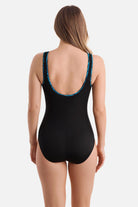 Woman turned away wearing a black one-piece swimsuit with a blue braided piping on the edges
