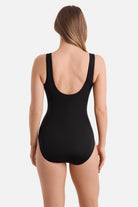 Woman turned away wearing a black one-piece swimsuit with a scoop back 