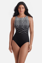 Woman wearing a black and white abstract pattern one-piece swimsuit