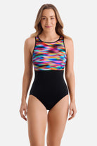 Woman wearing a rainbow tie dye one-piece swimsuit