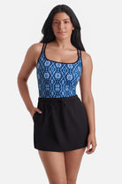 Woman wearing a blue tile print one-piece swim dress