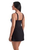 Woman turned left wearing a blue tile print one-piece swim dress