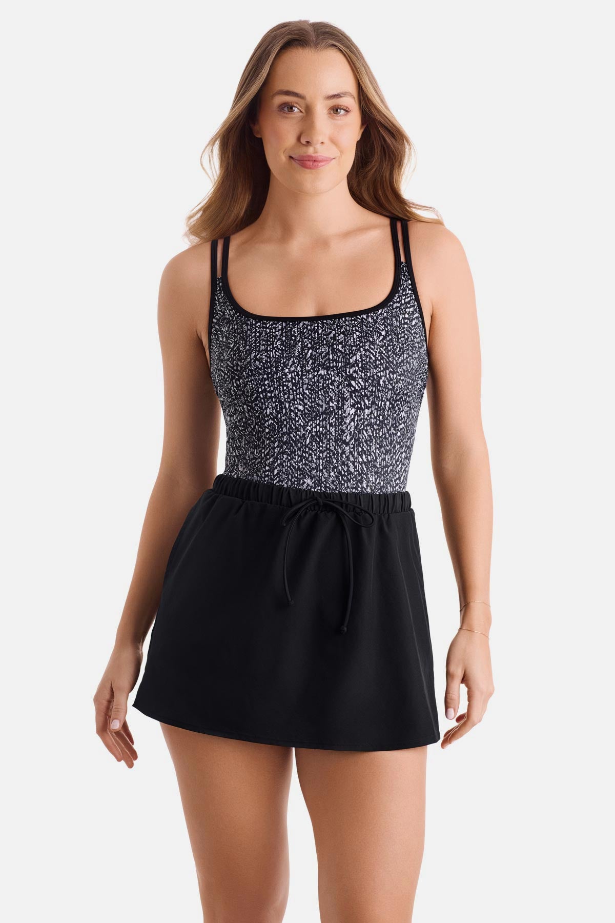 Woman wearing a black and white abstract printed swim dress