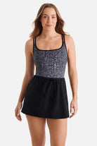 Woman wearing a black and white abstract printed swim dress