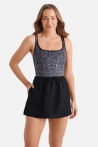 Woman wearing a black and white abstract printed swim dress