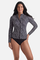 Woman wearing a black and white maze pattern sunshirt