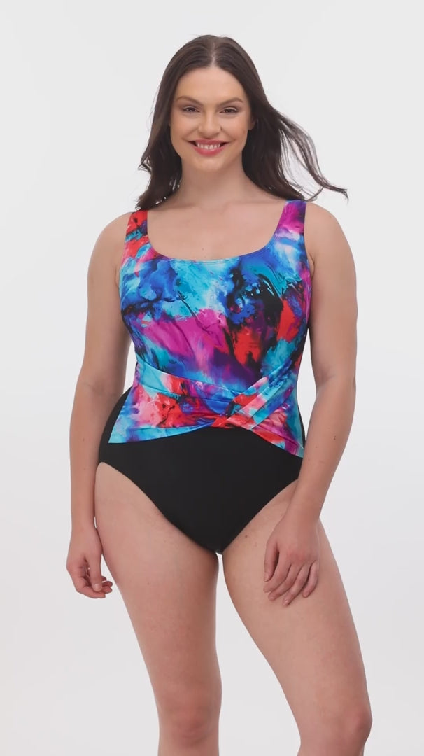 Woman wearing a blue and pink watercolor print one-piece swimsuit