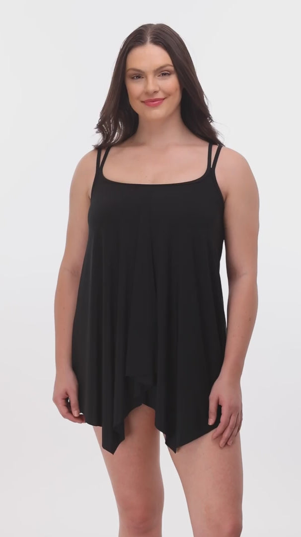 Woman wearing a black drapey swim dress