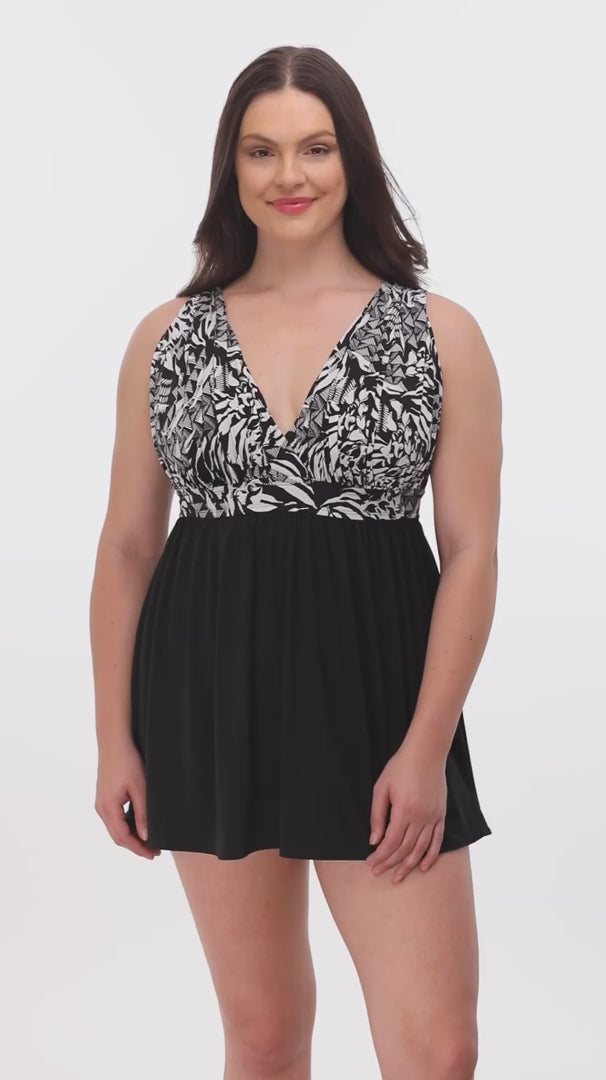 Woman wearing a black and white abstract printed at the bust swim dress