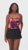 Woman wearing a multicolored watercolor swim dress with a sweetheart neckline