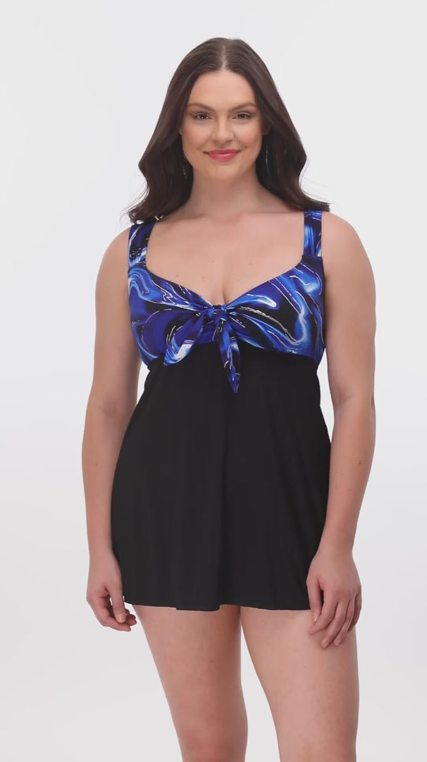 Woman wearing a blue and black oil slick printed bust swim dress
