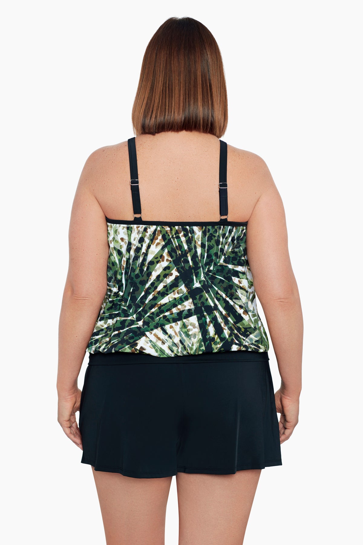 Woman turned away wearing a green and white palm leaf blouson tankini top