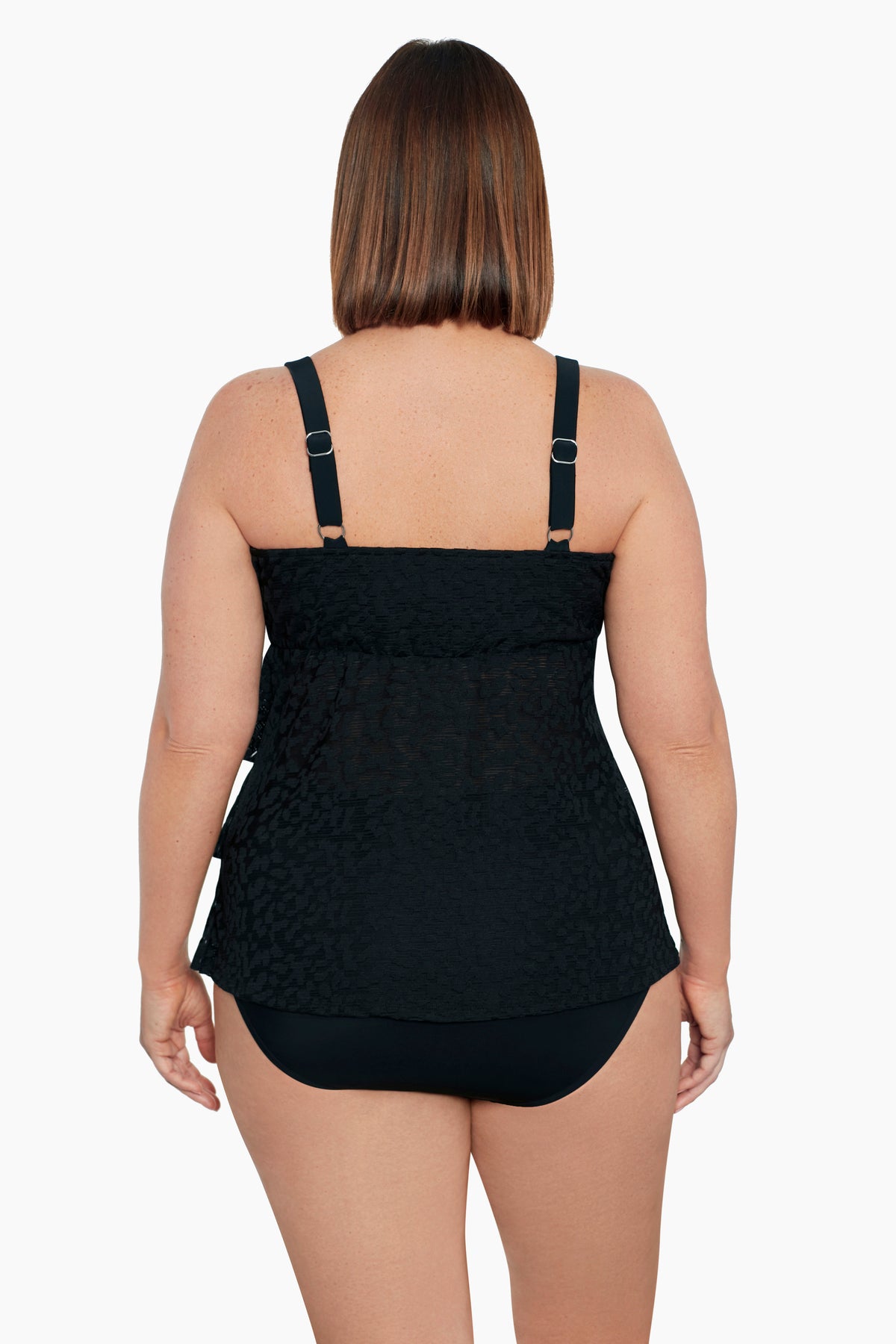 Woman faced away wearing a black ruffled faux tankini one-piece swimsuit with a faint animal print pattern