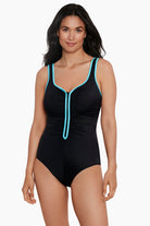 Woman wearing a black one-piece swimsuit with light blue piping down the front and on the straps